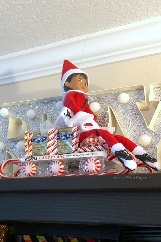 Elf on the Shelf ideas: riding on a candy sleigh