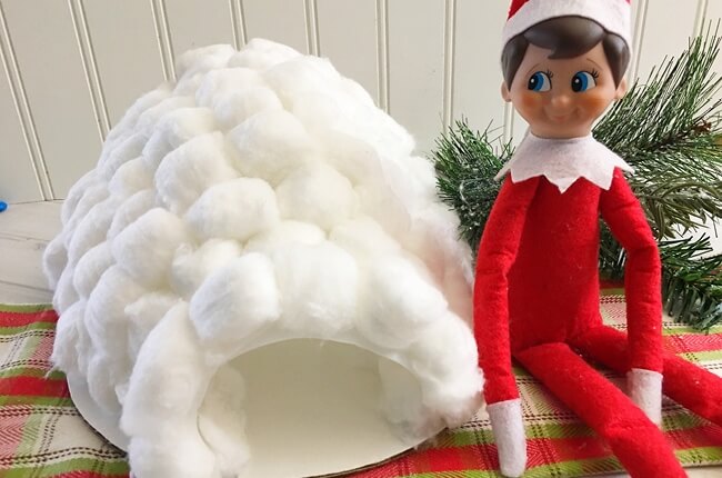 Elf building an igloo out of cotton balls
