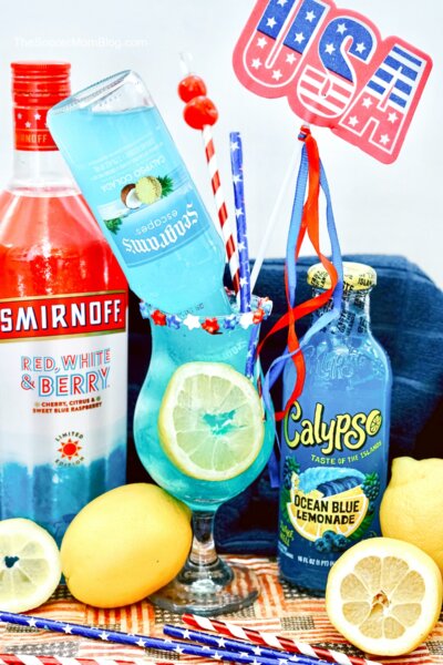 bright blue electric lemonade cocktail with patriotic decorations