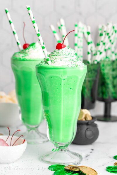 two bright green homemade Shamrock Shakes with St. Patrick's Day decor