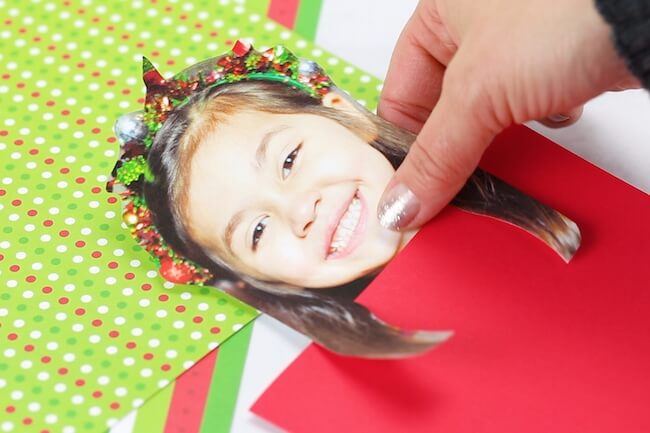 gluing child's photo to Christmas card