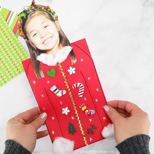 It may be called "ugly" but this Ugly Sweater Christmas Card is one of the CUTEST kid-made Christmas card ideas ever! And it's super easy to make!