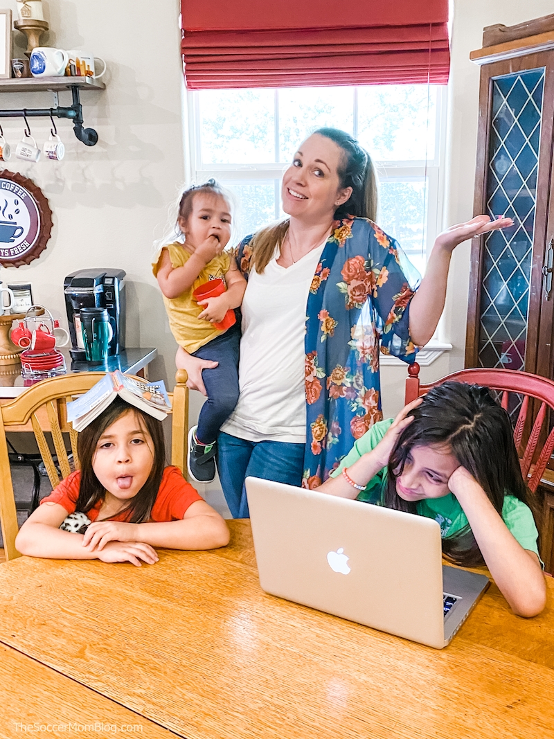 exasperated mom with kids homeschooling at kitchen table
