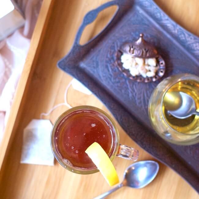 Hot tea on tray with honey and ginger